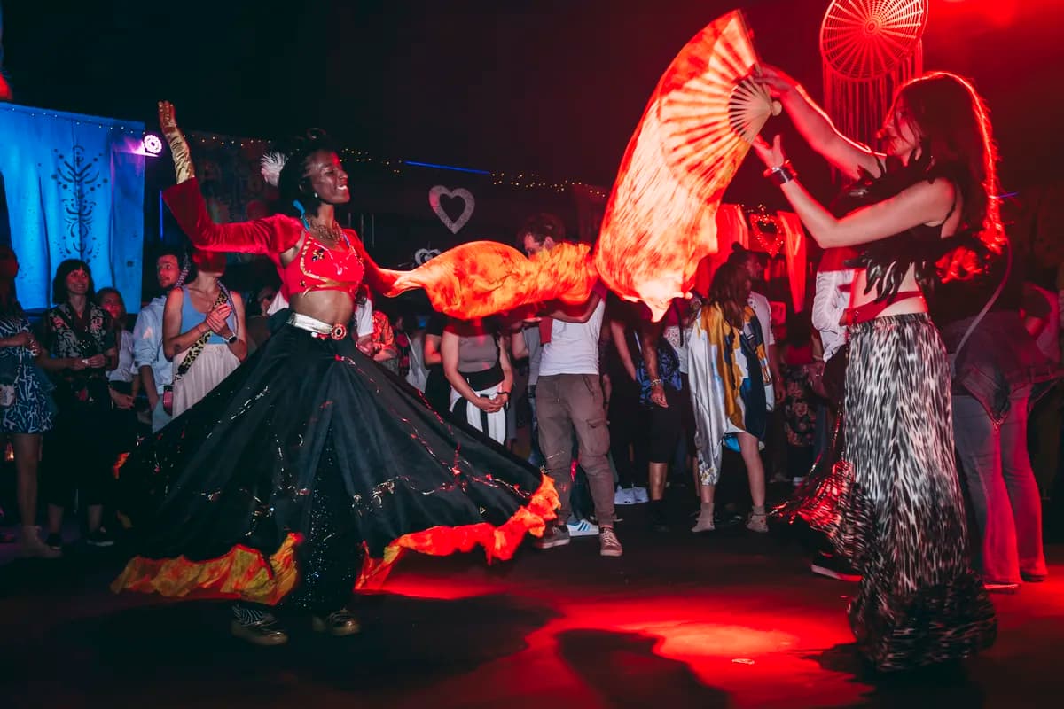 Fire performers dancing on stage at a Muzika Organika event
